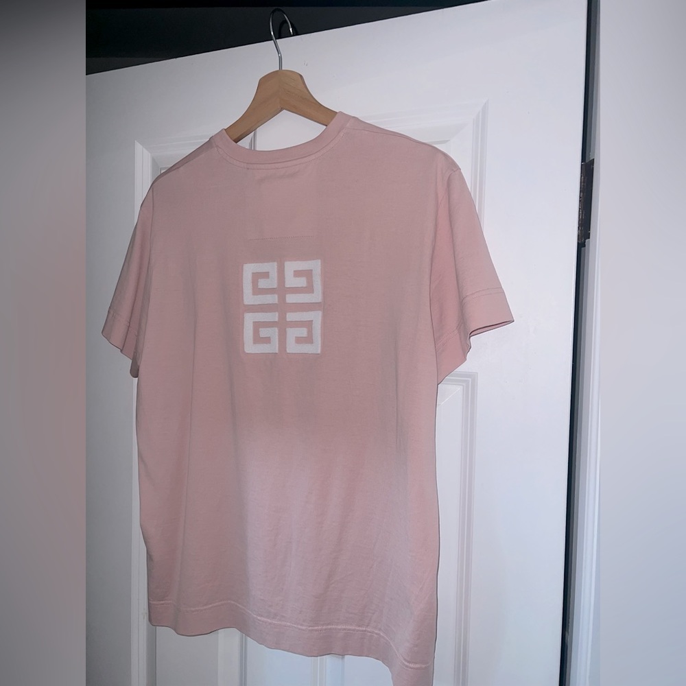 Given by pink shirt